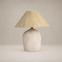 Sand porcelain table lamp with a textured base and woven straw shade.