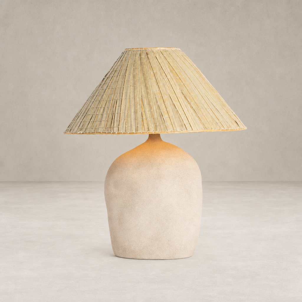 Sand porcelain table lamp with a textured base and woven shade.