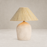Sand porcelain table lamp with a textured base and woven shade.