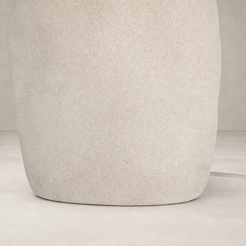 Sand porcelain table lamp with a smooth, rounded base and minimalist design.