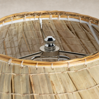 Sand porcelain table lamp featuring a woven texture and polished chrome fixture.