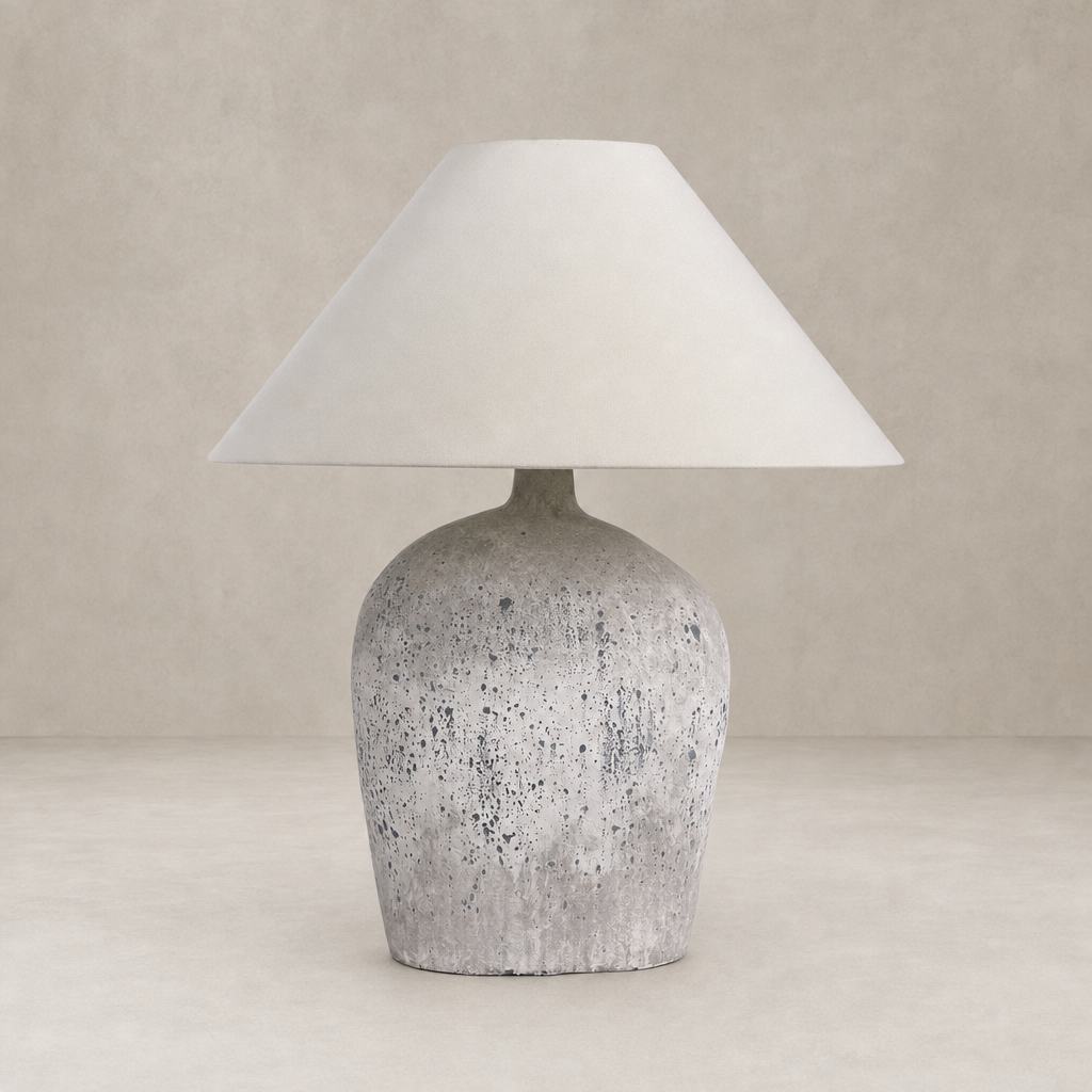 Antique white ceramic table lamp with a conical shade and textured base.