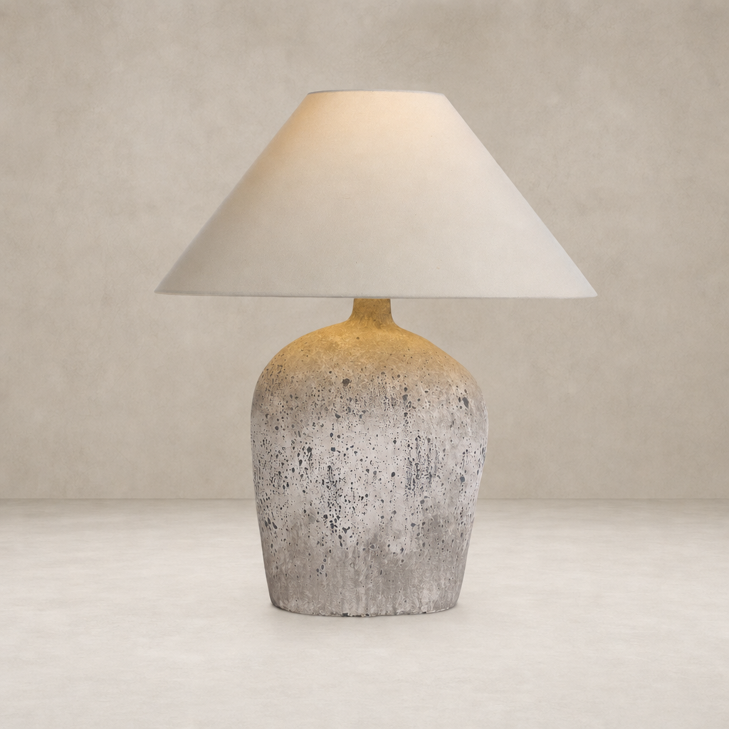 Antique white ceramic table lamp with a conical shade and textured base.