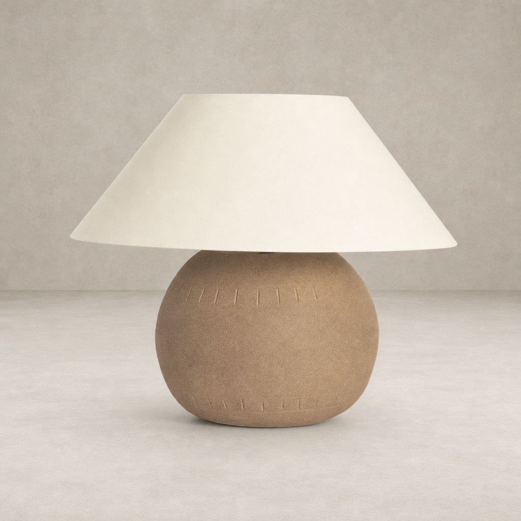 Dark sand porcelain ceramic table lamp with a wide white shade and textured base.