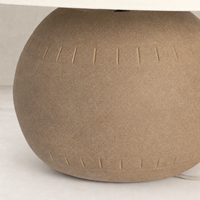 Dark sand porcelain ceramic table lamp with textured rounded base.