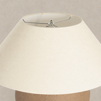 Dark sand porcelain ceramic table lamp with a beige fabric shade.