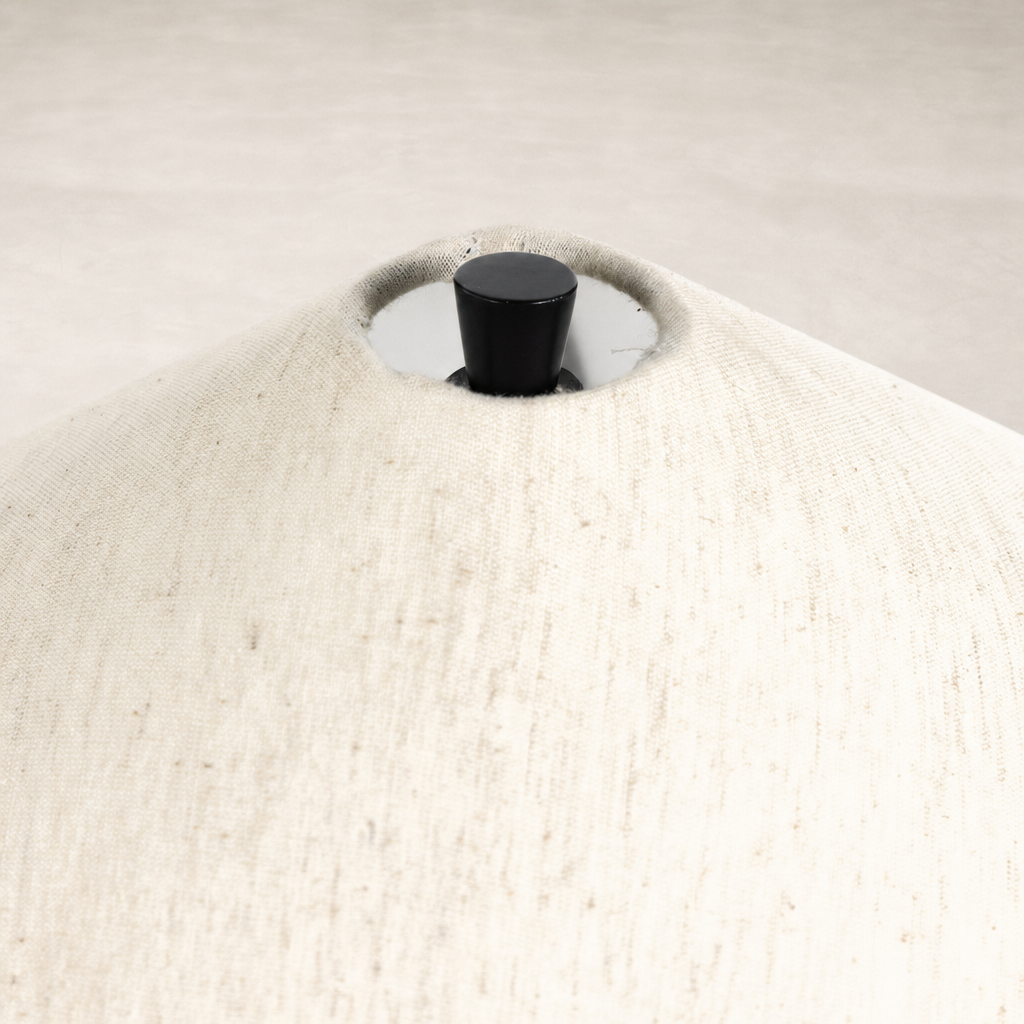Close-up of a tapered shade table lamp in matte black cast aluminum finish.