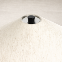 Close-up of a tapered shade table lamp in matte black cast aluminum finish.