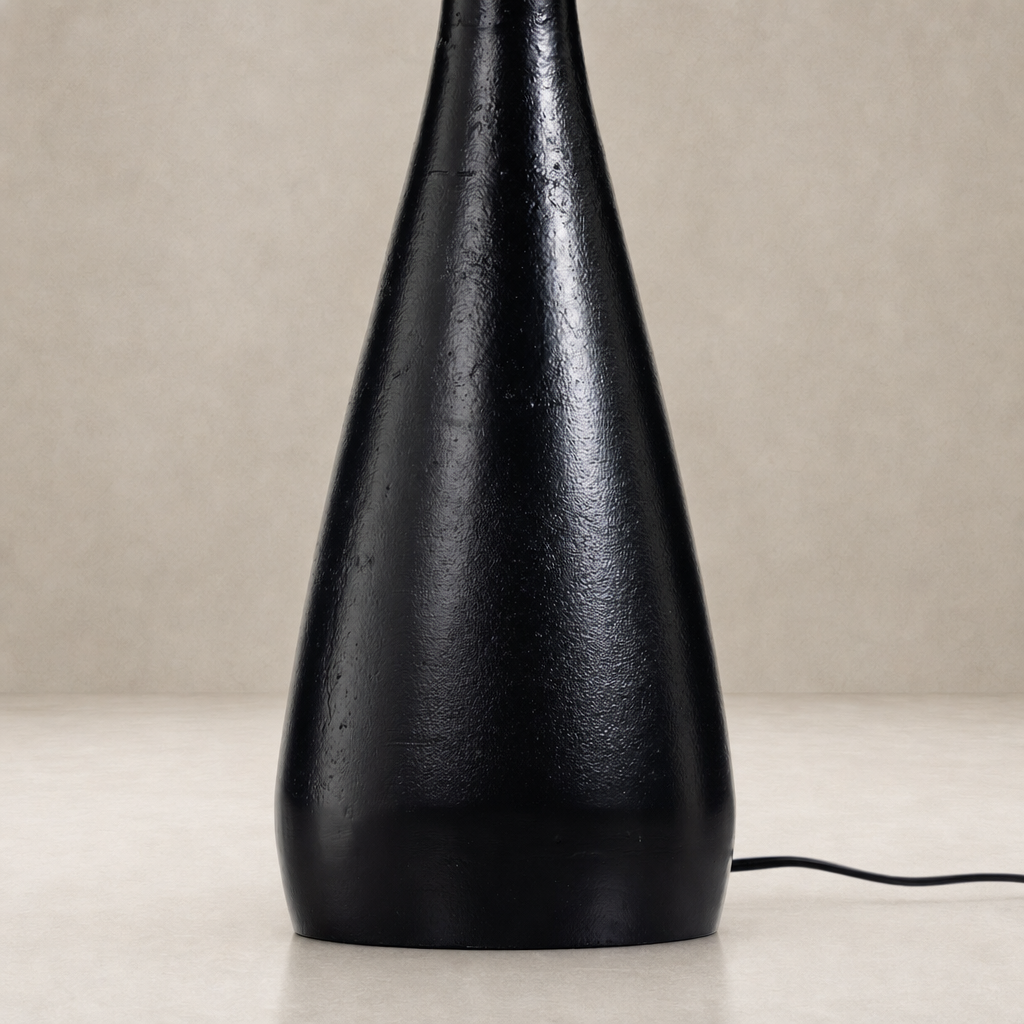 Matte black cast aluminum tapered shade table lamp with a textured finish.