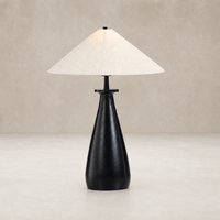 Matte black cast aluminum tapered shade table lamp with a light fabric lampshade.