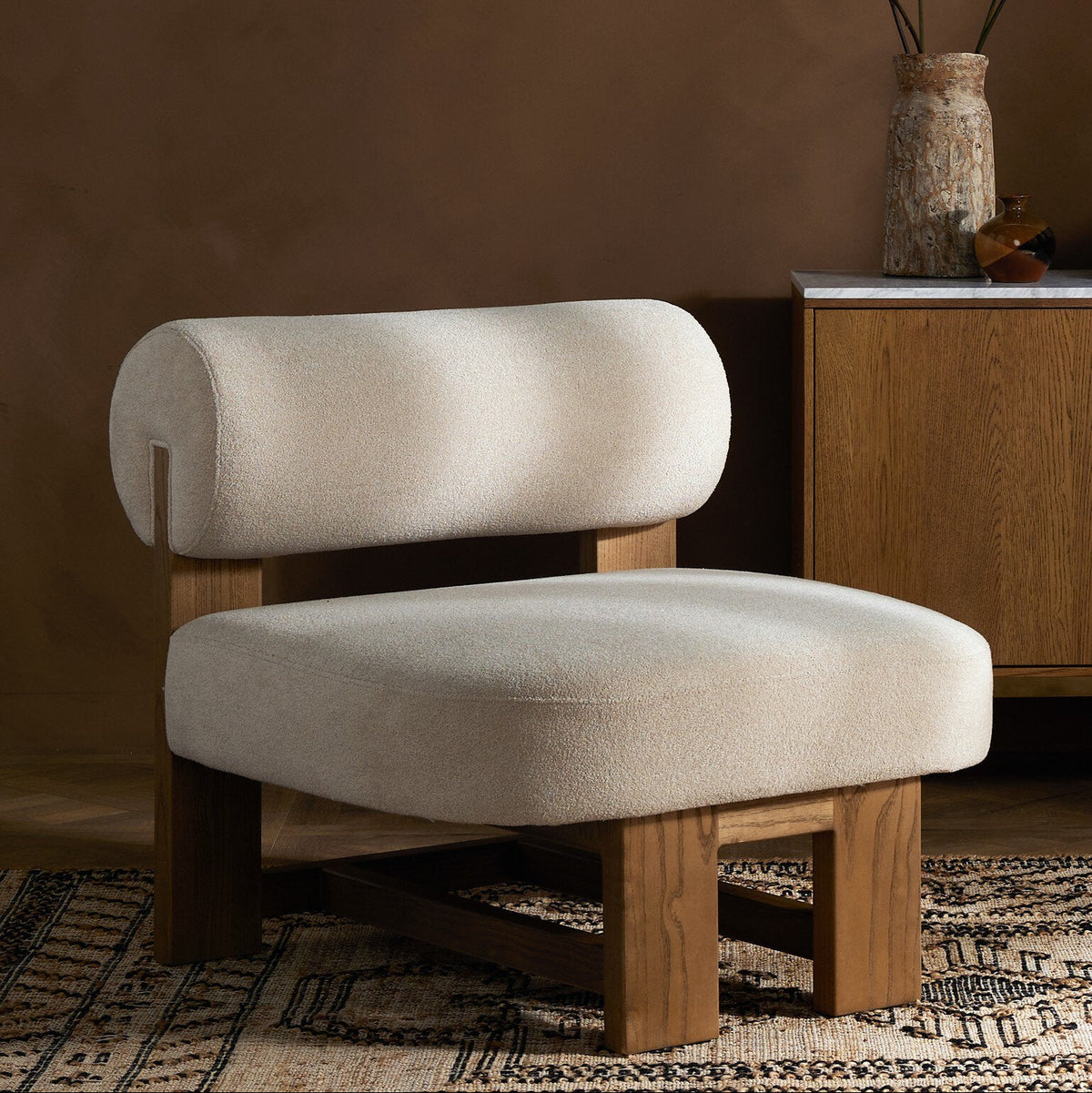 Isla Chair in Piermont Oyster with a plush, rounded back and sturdy wooden base.