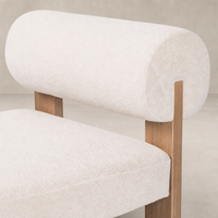 Isla Chair in Piermont Oyster features rounded backrest and wooden frame.