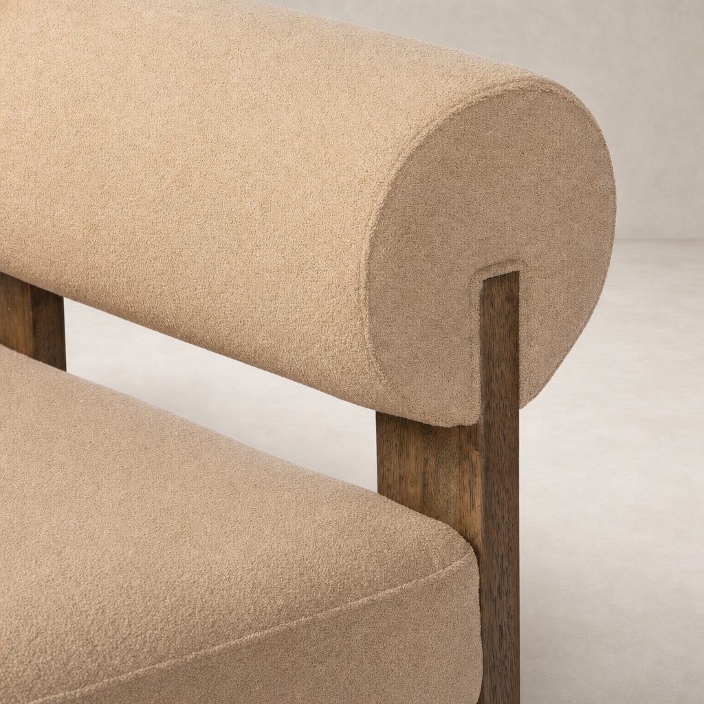 Isla Chair in Piermont Sand featuring a rounded back and wooden legs.