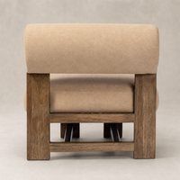 Isla Chair in Piermont Sand features a plush rounded back and sturdy wooden base.
