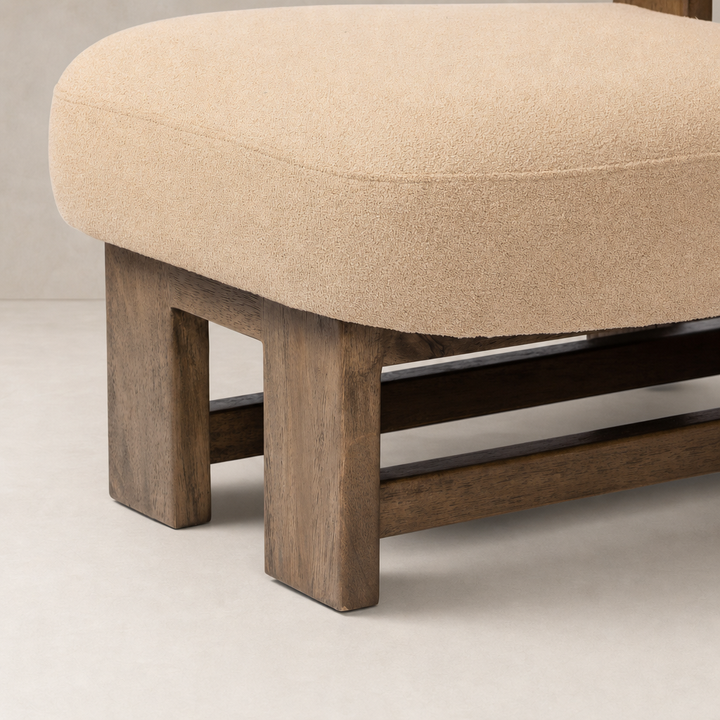 Isla Chair in Piermont Sand featuring a soft, rounded cushion and sturdy wooden legs.