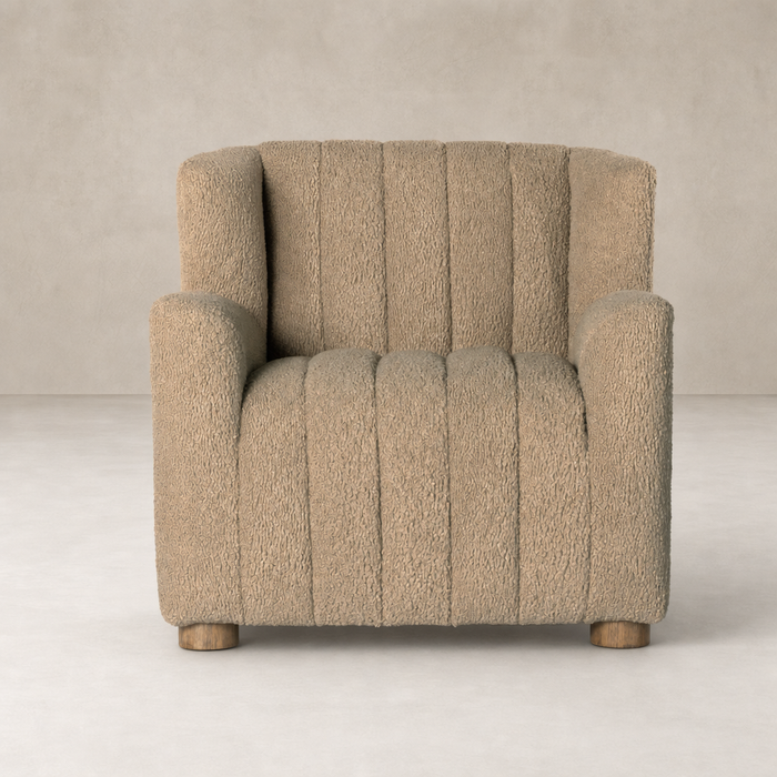 Baldwin Chair in sheepskin camel with a cozy, textured finish and sturdy wooden legs.