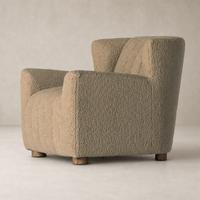 Baldwin Chair in Sheepskin Camel featuring a textured finish and sturdy wooden legs.