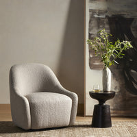 Rose Swivel Chair in Knoll Sand, featuring a cozy, curved design in a stylish living room.