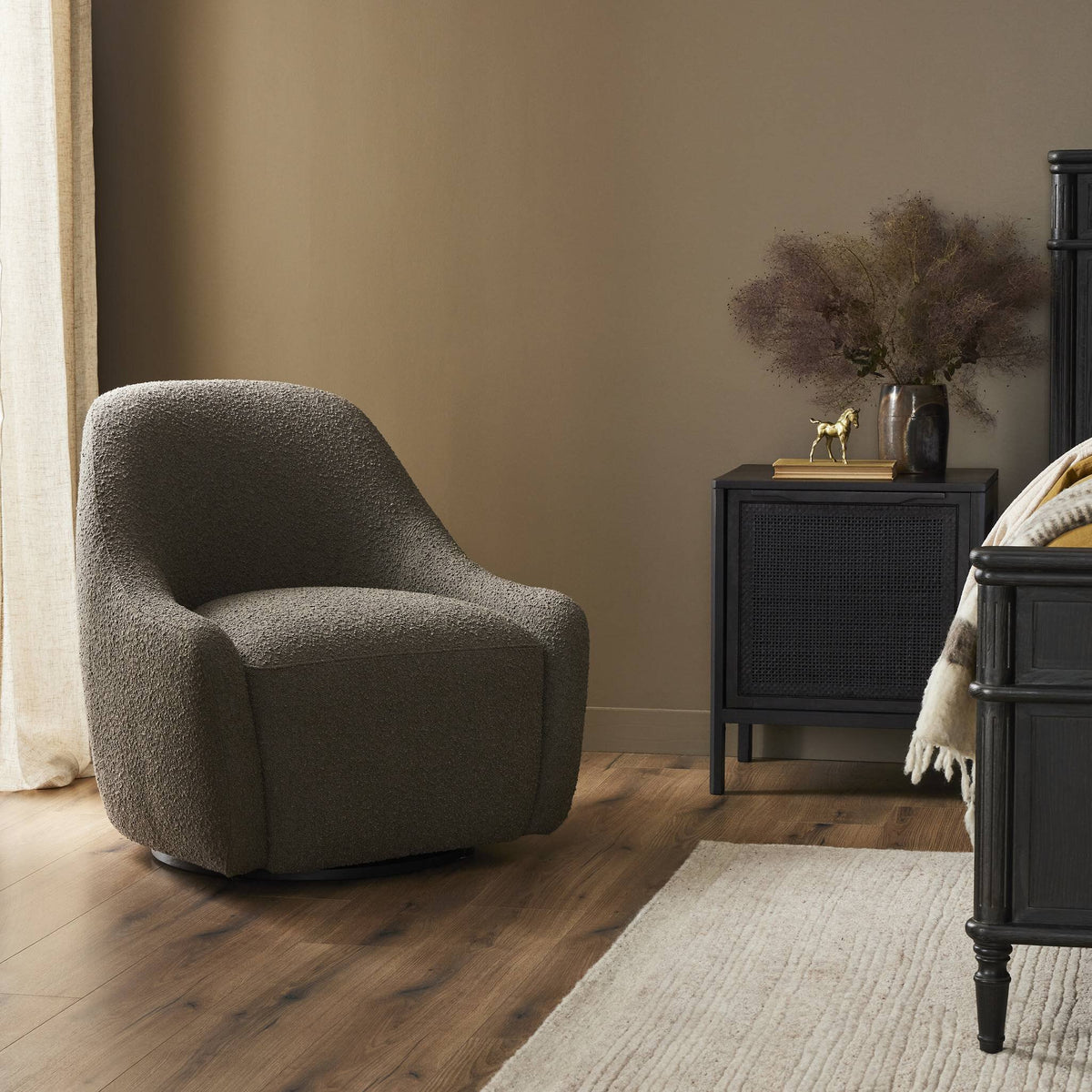 Rose Swivel Chair in Knoll Clay with a soft, textured finish in a cozy room setting.