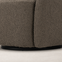 Close-up of the Rose Swivel Chair in Knoll Clay, showcasing its textured fabric and curved design.