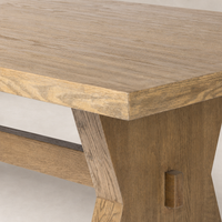 Pelton Dining Table in drifted oak showcasing a textured surface and stylish angled legs.