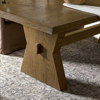 Pelton Dining Table in Drifted Oak featuring a modern design and distinctive angular legs.