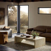 Bram Coffee Table in faux travertine, featuring a minimalist design and warm earthy tones.