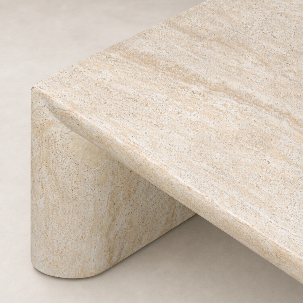 Bram Coffee Table features a sleek faux travertine finish with smooth curves.