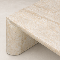 Bram Coffee Table features a sleek faux travertine finish with smooth curves.