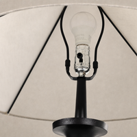 Matte black cast aluminum tapered shade floor lamp showcasing light bulb and socket details.