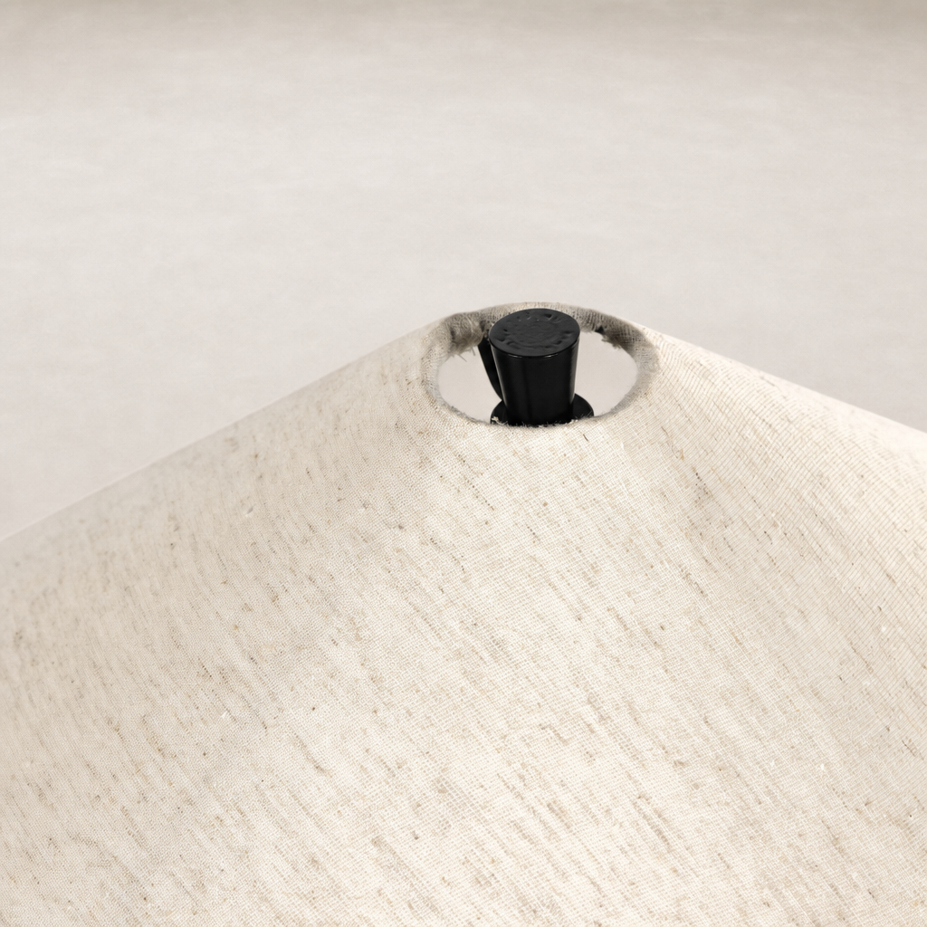 Close-up of tapered shade floor lamp with matte black cast aluminum fittings.