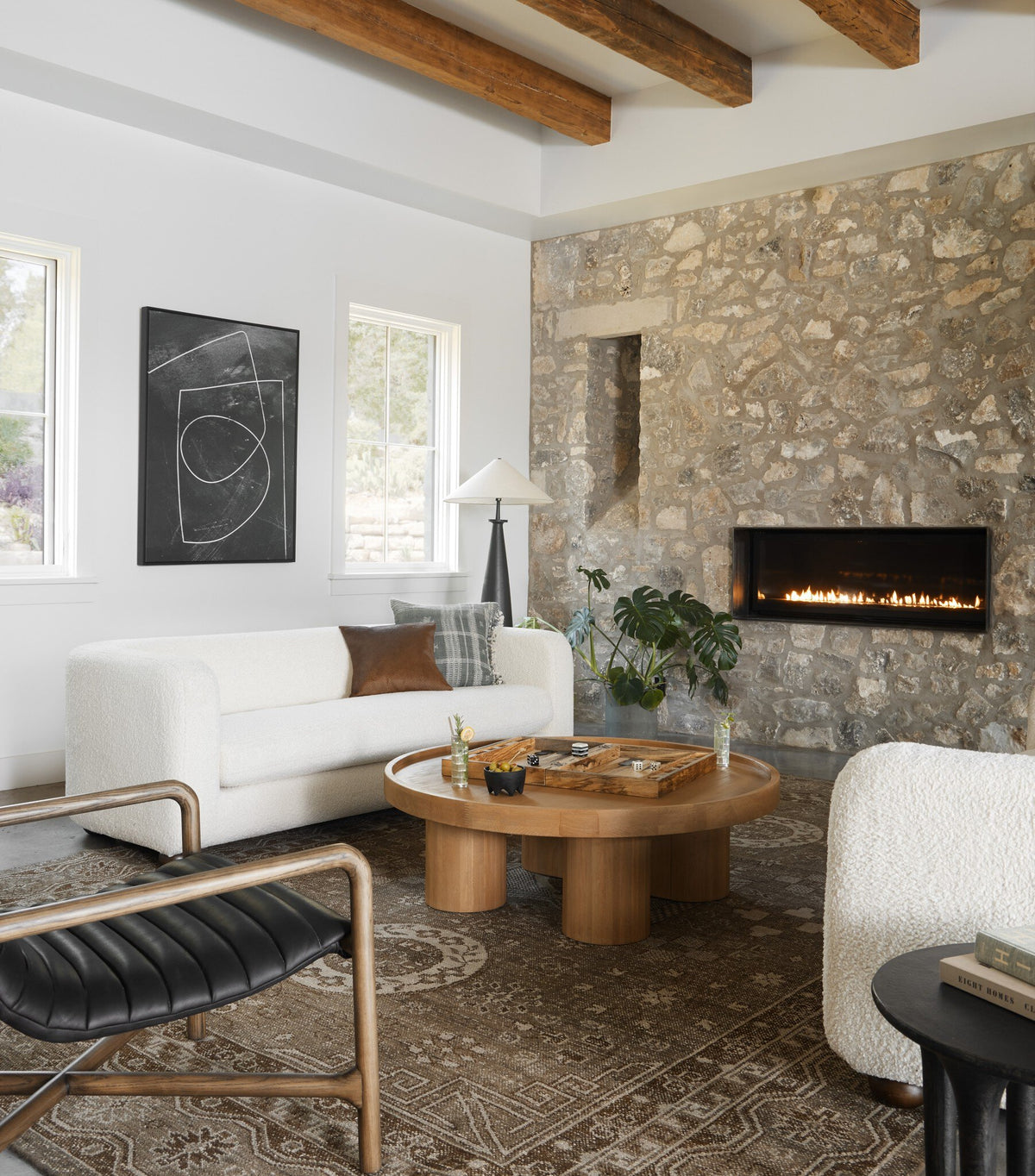 Matte black cast aluminum tapered shade floor lamp in stylish living room setting.