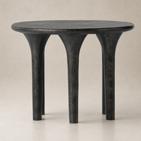 Holden End Table featuring a sleek round top and sturdy, sculptural legs.