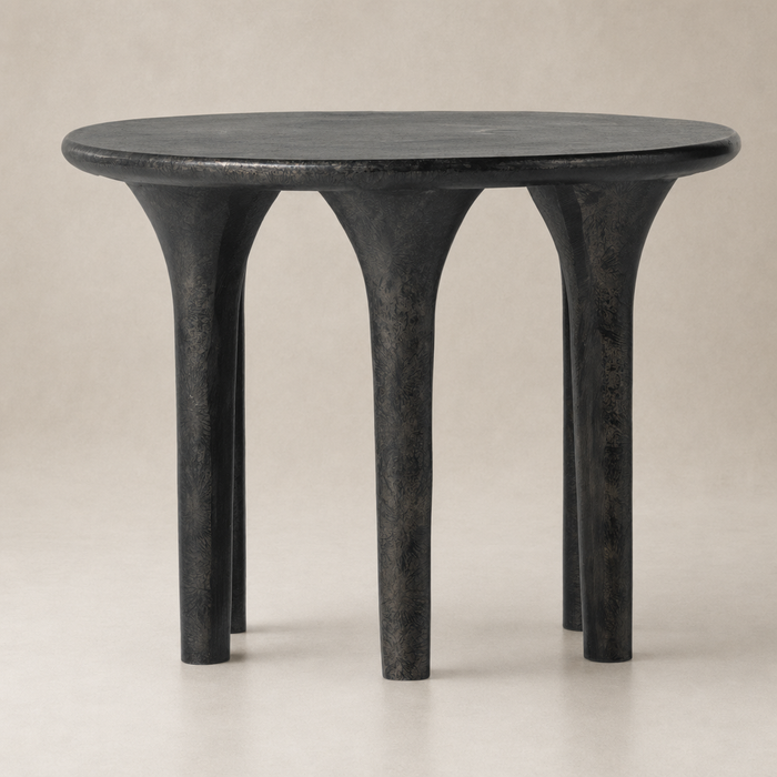Holden End Table featuring a sleek round top and sturdy, sculptural legs.
