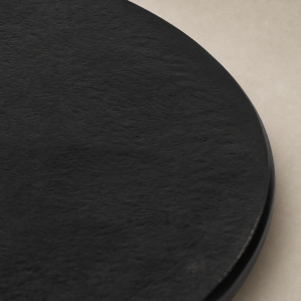 Close-up of the Holden End Table’s sleek black textured surface and rounded edges.