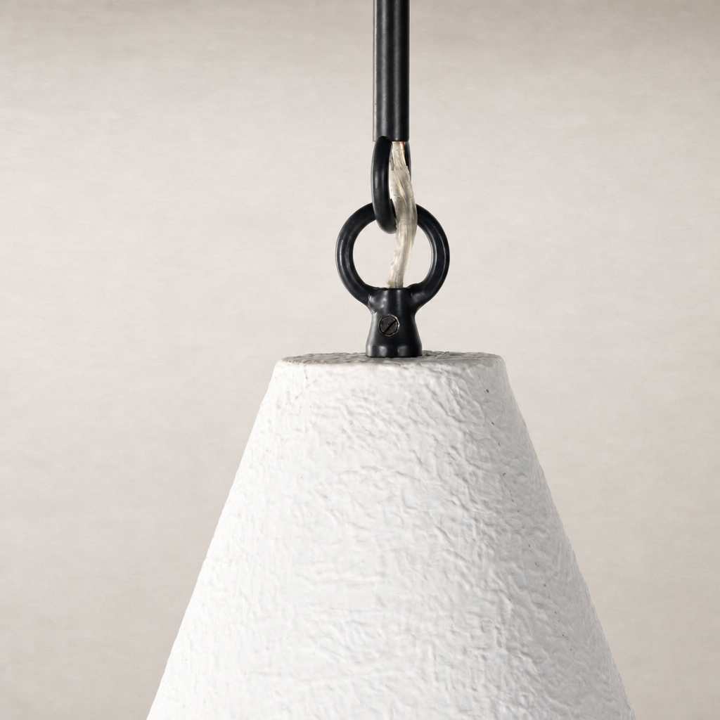 Matte white plaster pendant light with a textured finish and black hardware.
