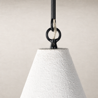 Matte white plaster pendant light with a textured finish and black hardware.