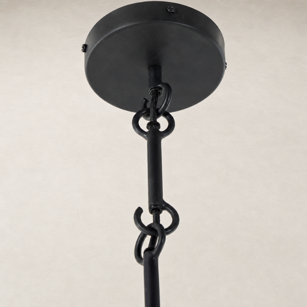 Matte black plaster pendant with a sleek design and sturdy hanging chain.