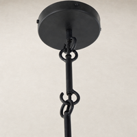 Matte black plaster pendant with a sleek design and sturdy hanging chain.