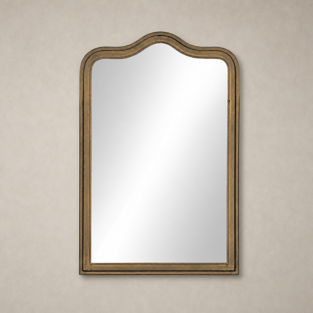 Elegant Etta Mirror in Raw Antique Brass Iron with a wavy top design.
