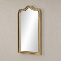 Etta Mirror in raw antique brass iron with an elegant arched top design.