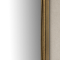 Etta Mirror featuring a sleek raw antique brass iron frame against a neutral background.