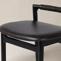 Nadia Bar + Counter Stool in Sonoma Black with sleek curves and a woven handle.