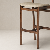 Nadia Bar + Counter Stool in Alcala Wheat with elegant wood frame and textured seat.