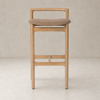 Nadia Bar + Counter Stool in Antwerp Cafe features a sleek wooden design with a plush seat.