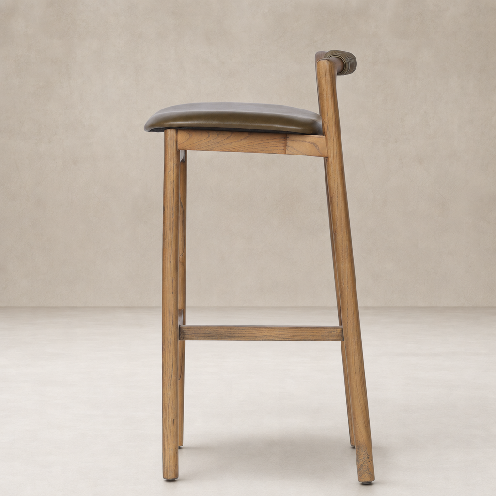 Nadia Bar + Counter Stool in Dulane Moss with a sleek wooden frame and curved backrest.