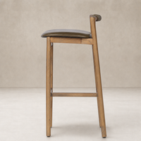 Nadia Bar + Counter Stool in Dulane Moss with a sleek wooden frame and curved backrest.