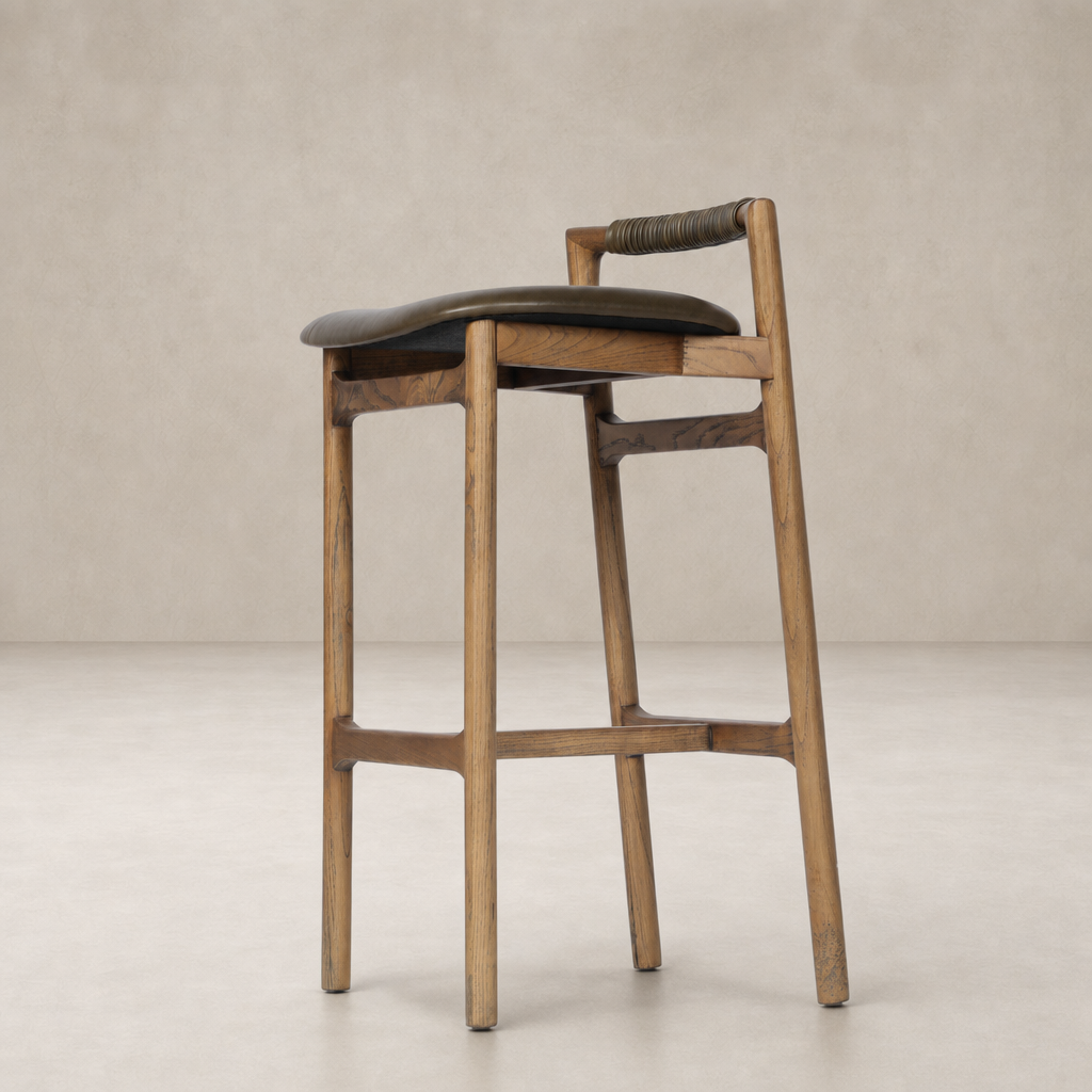 Nadia Bar + Counter Stool in Dulane Moss with warm wood finish and curved seat.