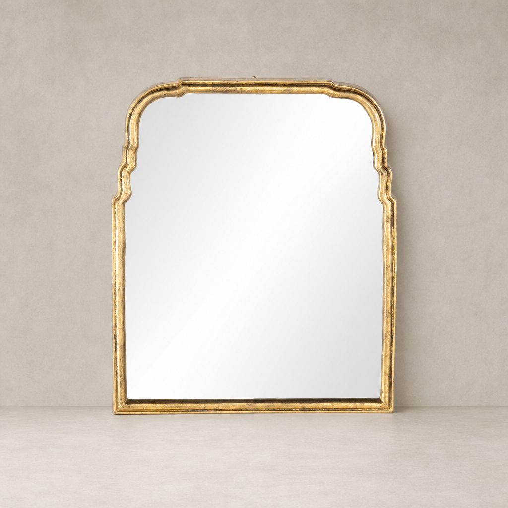 Antiqued Gold Leaf Rhone Mirror with intricate arched detailing and a reflective surface.