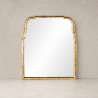 Antiqued Gold Leaf Rhone Mirror with intricate arched detailing and a reflective surface.